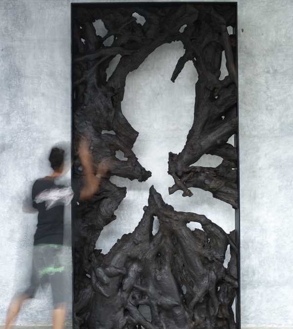 25 Large teak root sculpture in iron frame